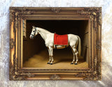 Gilt Framed Oleograph of a White Racehorse with a Red Blanket in a Stable